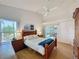 Bright main bedroom with vaulted ceiling, wood floors, and views of the backyard at 2126 Burley Ave, Clermont, FL 34711