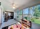 Bright sunroom with ceiling fan, tile floor, and views of the landscaped yard at 2126 Burley Ave, Clermont, FL 34711