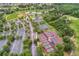 Aerial view of community amenities including tennis courts, baseball field, and parking at 2129 Palm Tree Dr, Poinciana, FL 34759