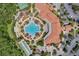 Aerial view of the community amenities, featuring a pool, tennis courts, and parking at 2129 Palm Tree Dr, Poinciana, FL 34759