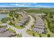 Expansive aerial view of a residential neighborhood with lush greenery and a lake at 2129 Palm Tree Dr, Poinciana, FL 34759