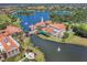 Stunning aerial view of a resort-style community with a picturesque lake and fountains at 2129 Palm Tree Dr, Poinciana, FL 34759
