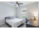 A small bedroom with carpet flooring, desk, fan, and natural light at 2129 Palm Tree Dr, Poinciana, FL 34759