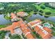 Aerial view showcasing the community's lakeside setting, clubhouse, and various amenities with lush landscaping at 2129 Palm Tree Dr, Poinciana, FL 34759