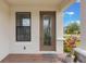 Inviting front entry featuring a decorative glass door, sidelight window, and brick paver porch at 2129 Palm Tree Dr, Poinciana, FL 34759