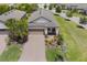 Charming single-story home featuring a well-manicured lawn and a brick driveway, complete with a two-car garage at 2129 Palm Tree Dr, Poinciana, FL 34759