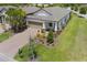 Beautiful single-Gathering home showcasing a lush front lawn and a two-car garage, complemented by mature trees at 2129 Palm Tree Dr, Poinciana, FL 34759