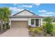 Charming one-story home with a well-manicured lawn, paver driveway, and a two-car garage at 2129 Palm Tree Dr, Poinciana, FL 34759