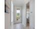 Bright hallway with shuttered window, stylish tiled floors, leading to laundry room at 2129 Palm Tree Dr, Poinciana, FL 34759