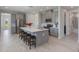 Modern kitchen with gray cabinets, stainless steel appliances, a quartz countertop island, and wood-look tile flooring at 2129 Palm Tree Dr, Poinciana, FL 34759