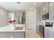 Bright kitchen featuring a large island with seating, stainless steel appliances, and stylish gray cabinetry at 2129 Palm Tree Dr, Poinciana, FL 34759