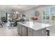 Open-concept kitchen flows into the dining and living areas with a spacious island and modern finishes throughout at 2129 Palm Tree Dr, Poinciana, FL 34759
