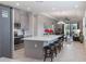 Open-concept kitchen with island seating, stainless appliances, flows into dining and living areas at 2129 Palm Tree Dr, Poinciana, FL 34759