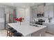 Contemporary kitchen boasts a sizable island with bar stools, stainless steel appliances, and elegant gray cabinets at 2129 Palm Tree Dr, Poinciana, FL 34759