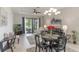 This open-concept living room has a modern chandelier and a view of the backyard at 2129 Palm Tree Dr, Poinciana, FL 34759