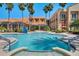 Resort-style outdoor pool with inviting spa and sun loungers surrounded by palm trees at 2129 Palm Tree Dr, Poinciana, FL 34759