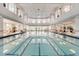 Spacious indoor pool area featuring multiple lanes and large windows for natural light at 2129 Palm Tree Dr, Poinciana, FL 34759