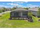A tranquil backyard retreat with a screened lanai, perfect for enjoying the outdoors in comfort and style at 2129 Palm Tree Dr, Poinciana, FL 34759