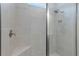 Walk-in shower with sleek tile and a built-in niche offers a modern and convenient bathing experience at 2129 Palm Tree Dr, Poinciana, FL 34759
