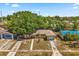 An aerial shot of the single Gathering home with a blue tarp in the back at 2252 Kent Rd, Deltona, FL 32738