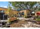 Backyard of yellow home with a metal plant trellis, shed and mature trees at 2252 Kent Rd, Deltona, FL 32738