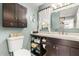 Well-organized bathroom with vanity, toilet, storage shelves, and decorative accents at 2252 Kent Rd, Deltona, FL 32738