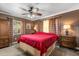 Brown bedroom with wooden furniture, ceiling fan, and plaid curtains at 2252 Kent Rd, Deltona, FL 32738