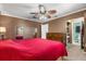 Primary bedroom boasts a ceiling fan, carpet, closet, and attached bathroom at 2252 Kent Rd, Deltona, FL 32738