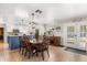 Dining area adjacent to a modern kitchen with a wooden table, seating for six, and natural light at 2252 Kent Rd, Deltona, FL 32738