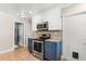 Well-equipped kitchen with stainless steel appliances, mosaic backsplash, and white upper and blue lower cabinets at 2252 Kent Rd, Deltona, FL 32738