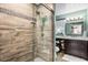 Bathroom shower featuring stylish wood-look tiles and modern fixtures at 2252 Kent Rd, Deltona, FL 32738