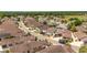 Picturesque aerial view of a residential neighborhood with mature trees and tidy landscaping near a green space at 2403 Muirwood Pl, The Villages, FL 32162