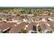 Scenic aerial shot of a tidy residential area boasting a golf course and homes with solar panels near a beautiful lake at 2403 Muirwood Pl, The Villages, FL 32162