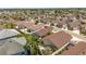 Bird's-eye view of a residential community, featuring tidy streets, similar home designs, and well-manicured lawns and landscaping at 2403 Muirwood Pl, The Villages, FL 32162