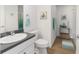 Well-lit bathroom featuring a vanity with storage, toilet, and a shower/tub combination with decorative accents at 2403 Muirwood Pl, The Villages, FL 32162