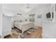 Serene bedroom with light-colored walls, wood floors, and a comfortable bed at 2403 Muirwood Pl, The Villages, FL 32162
