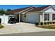 Charming home featuring a one car garage, well-maintained landscaping, and a private golf cart parking area at 2403 Muirwood Pl, The Villages, FL 32162