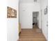 Bright foyer featuring a wood-look floor, beach decor, and a convenient coat rack for a welcoming first impression at 2403 Muirwood Pl, The Villages, FL 32162