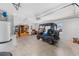 Bright and spacious garage with a golf cart, water heater, storage shelves, and garage door opener at 2403 Muirwood Pl, The Villages, FL 32162