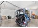 Spacious garage featuring a golf cart, storage shelves, water heater, and garage door at 2403 Muirwood Pl, The Villages, FL 32162