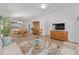 Open living space connecting the living room, dining area, and kitchen with natural light at 2403 Muirwood Pl, The Villages, FL 32162