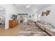 Bright living room with wood floors, neutral furniture, and a view of the backyard at 2403 Muirwood Pl, The Villages, FL 32162