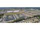 An aerial shot features the community with nearby shopping centers and roadways at 2482 Ansley Path, The Villages, FL 32162