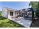Well-maintained backyard with a spacious patio featuring a screen enclosure, and lush green grass at 2482 Ansley Path, The Villages, FL 32162