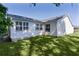 Lush green backyard with a well-maintained lawn and white vinyl siding at 2482 Ansley Path, The Villages, FL 32162