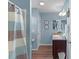 Charming blue bathroom featuring a shower/tub combination and vanity with plenty of counter space at 2482 Ansley Path, The Villages, FL 32162