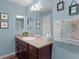 Well-lit bathroom with vanity, mirror, and decorative accents for a fresh and inviting space at 2482 Ansley Path, The Villages, FL 32162