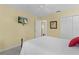 Bedroom with a queen bed, TV and ensuite bathroom and closet at 2482 Ansley Path, The Villages, FL 32162