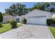 Beautiful home featuring a landscaped yard, paved driveway, and a two-car garage at 2482 Ansley Path, The Villages, FL 32162