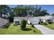 Single-story home featuring well-maintained landscaping and a decorative driveway at 2482 Ansley Path, The Villages, FL 32162